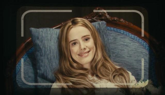 Angelica smiles at Issac through the camera lens