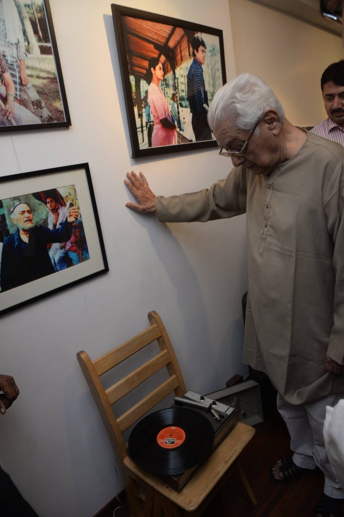 Basu Chatterji listening to an original LP record of one of his films