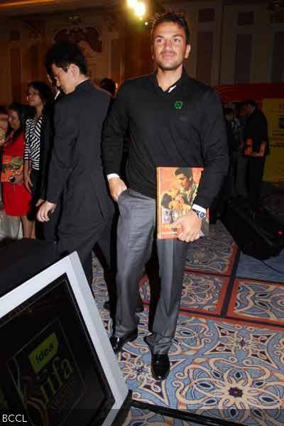 Peter Andre holding Bollywood in Posters book