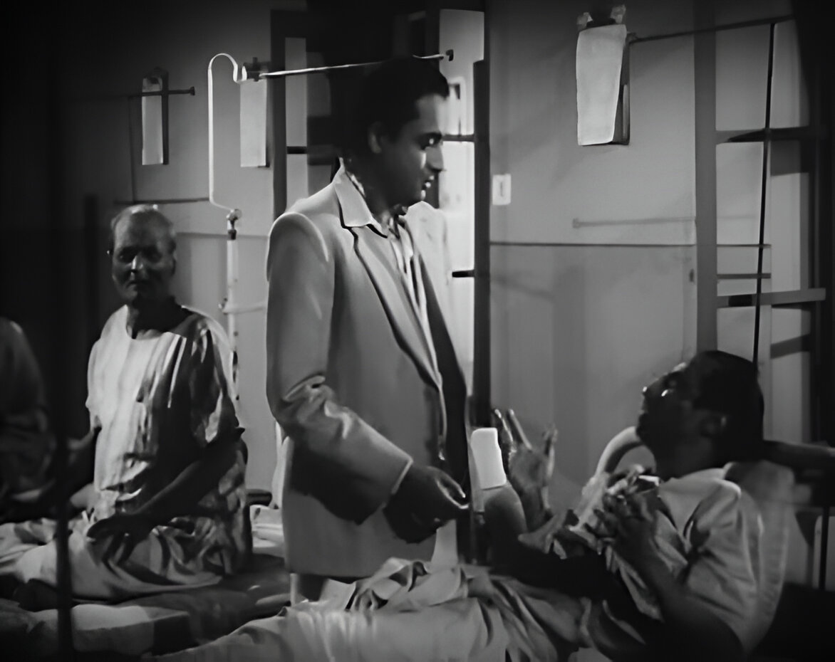 Nirmal Kumar as The doctor in Khaniker Atithi