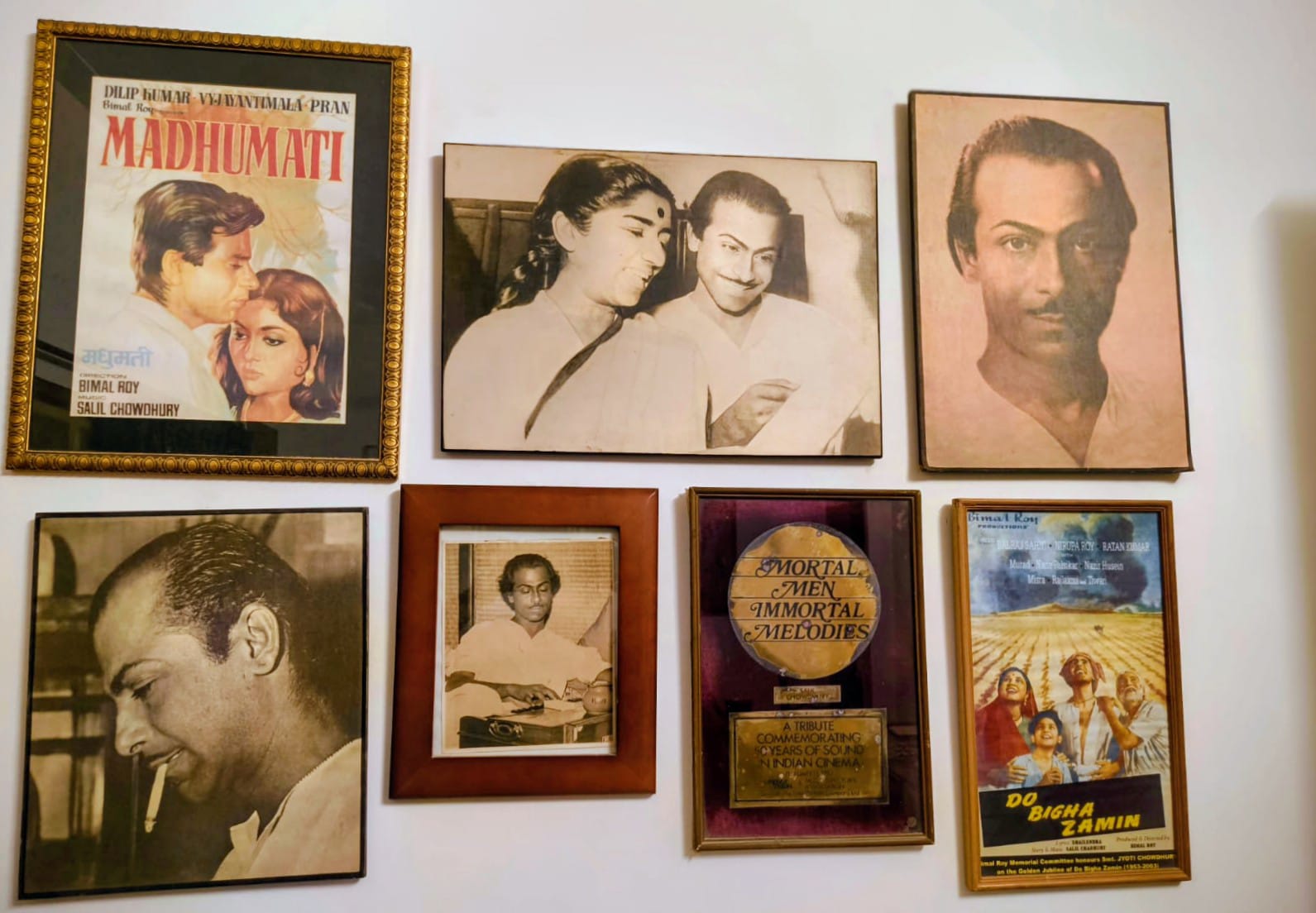 A wall in Jyoti Chowdhury's home displaying Salil Chowdhury's photographs and film posters