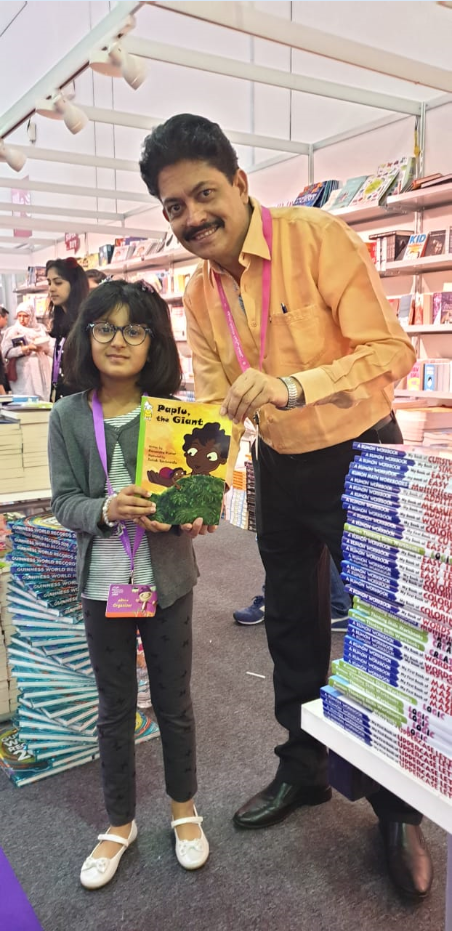 Ramendra Kumar with a young reader 